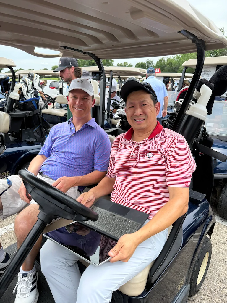 Fr. Ambrose and Alumnus smiling during the Reunion Weekend golf outing