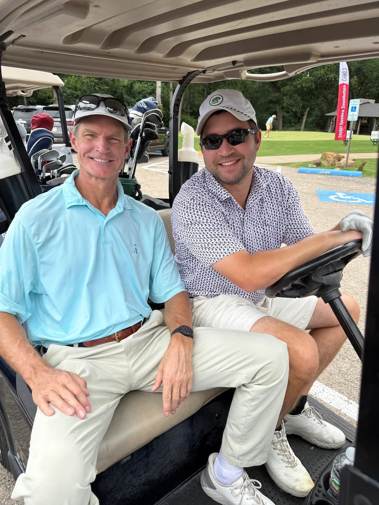 Golf outing participants traveling across the course