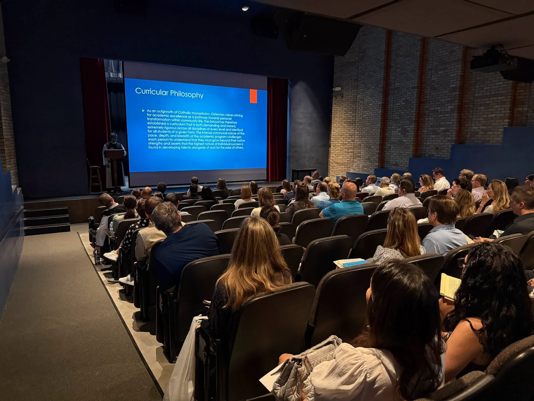 Fr. Philip giving a presentation in the theater