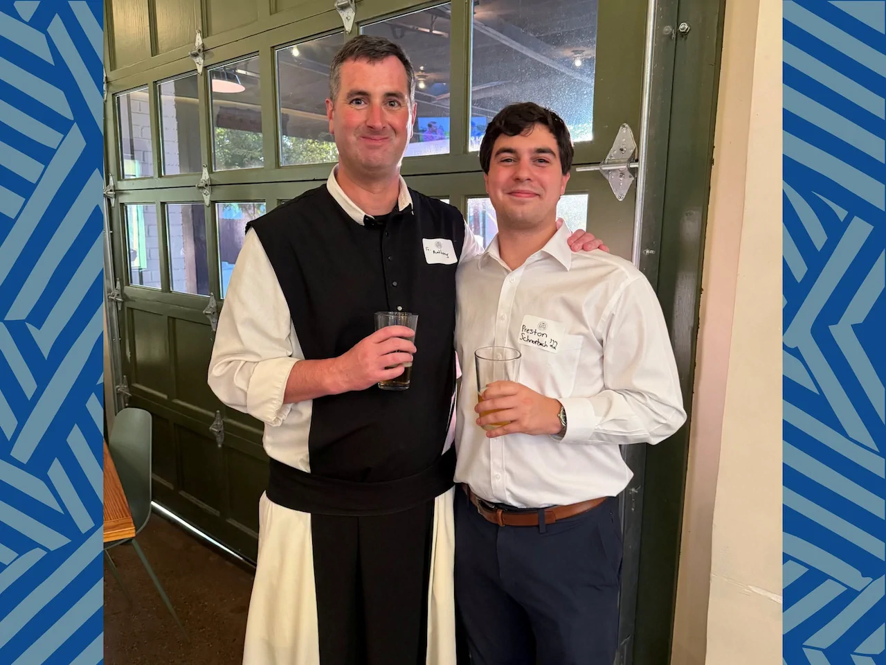 A Cistercian monk and alumnus posing together at the Class Agent and Alumni Board Gathering at Cenzo’s Pizza & Deli.
